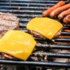 hamburgers with cheese and hot dogs on grill