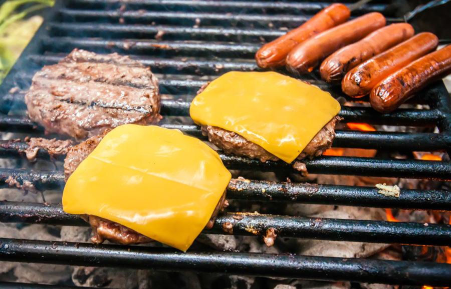 hamburgers with cheese and hot dogs on grill